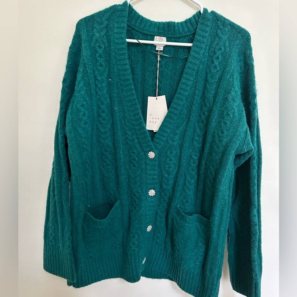 Oversized sweater with jewel button detail, pockets